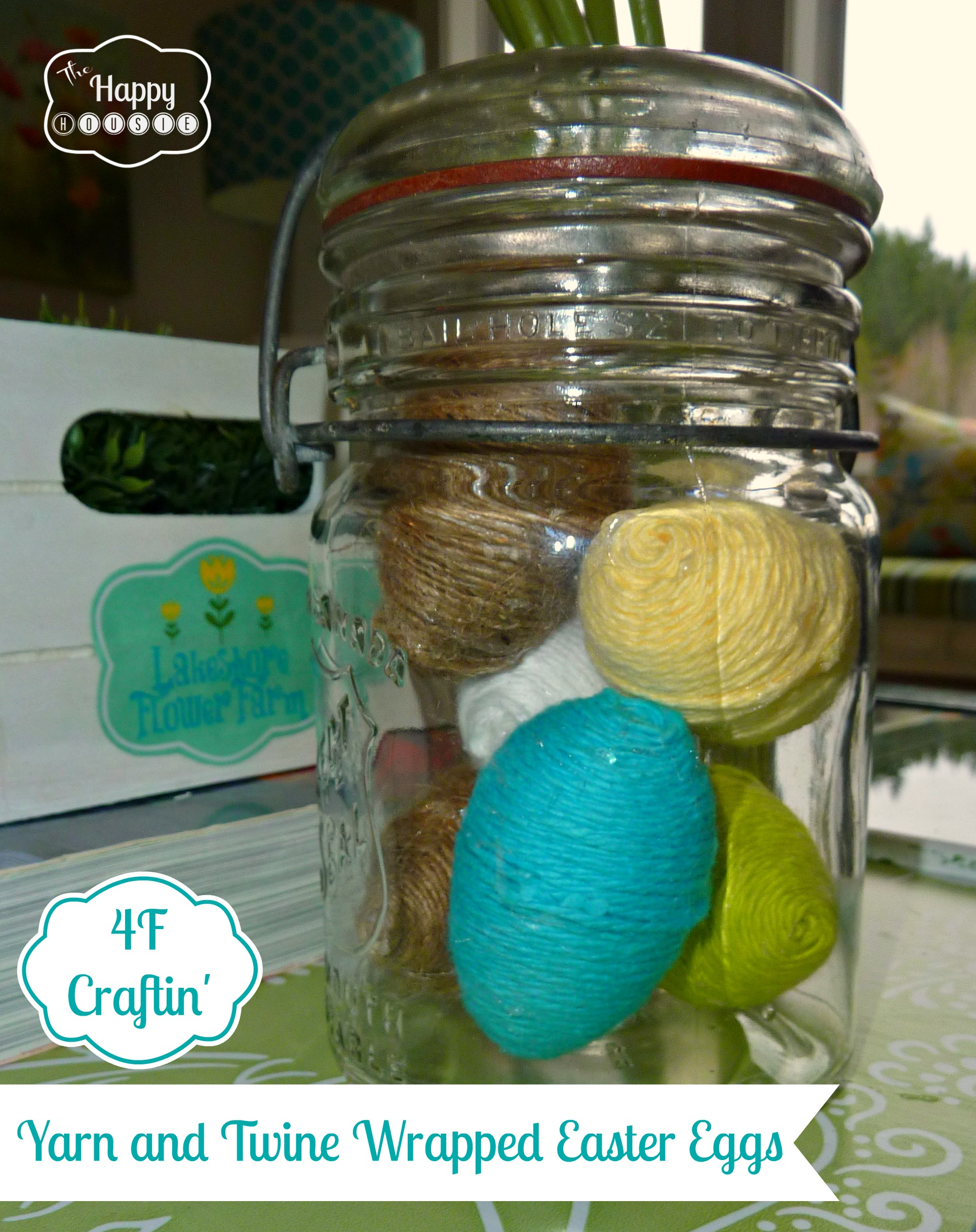 Turquoise, yellow and green wrapped Easter eggs in a glass jar.