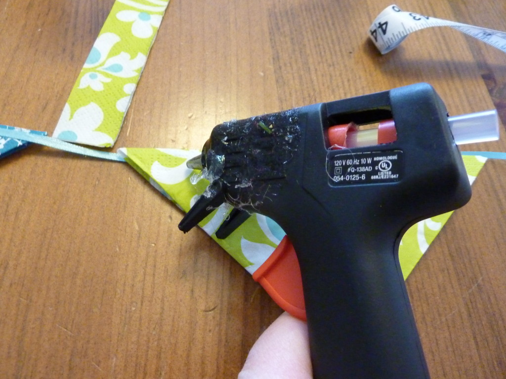 Using the hot glue gun on the napkins.