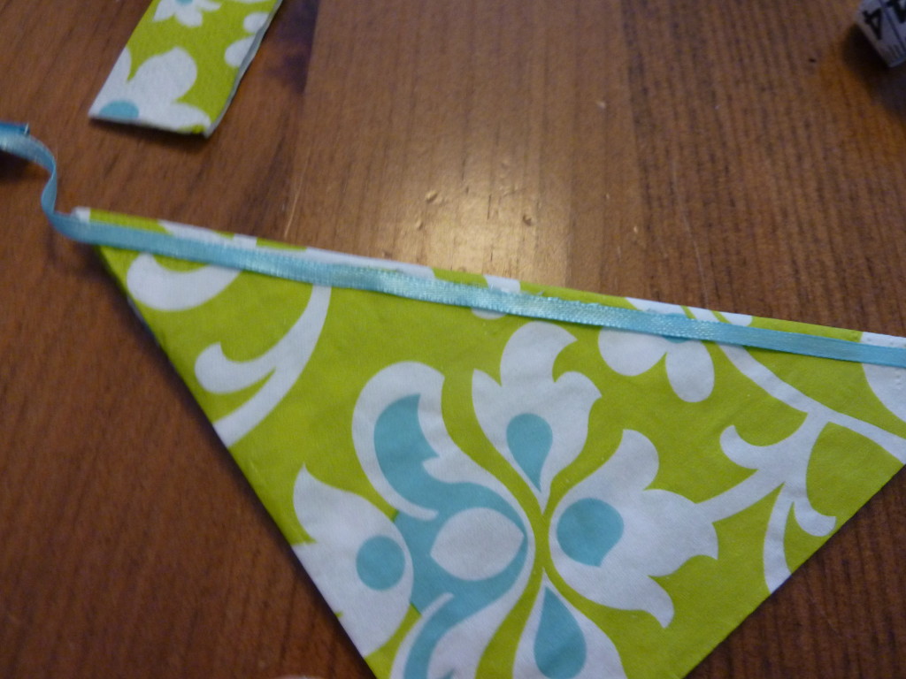 Attaching a silk blue ribbon to the napkin.