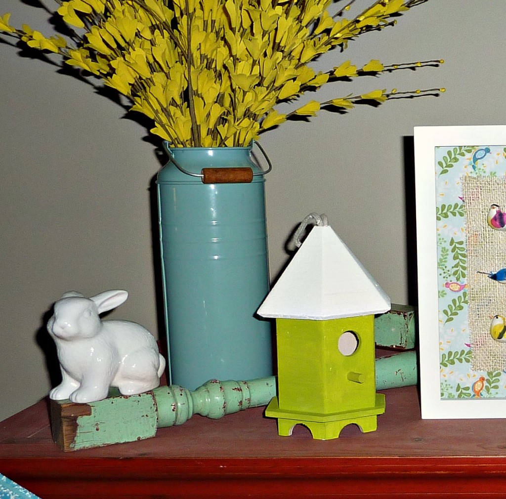 A small birdcage, small white bunny and yellow flowers.
