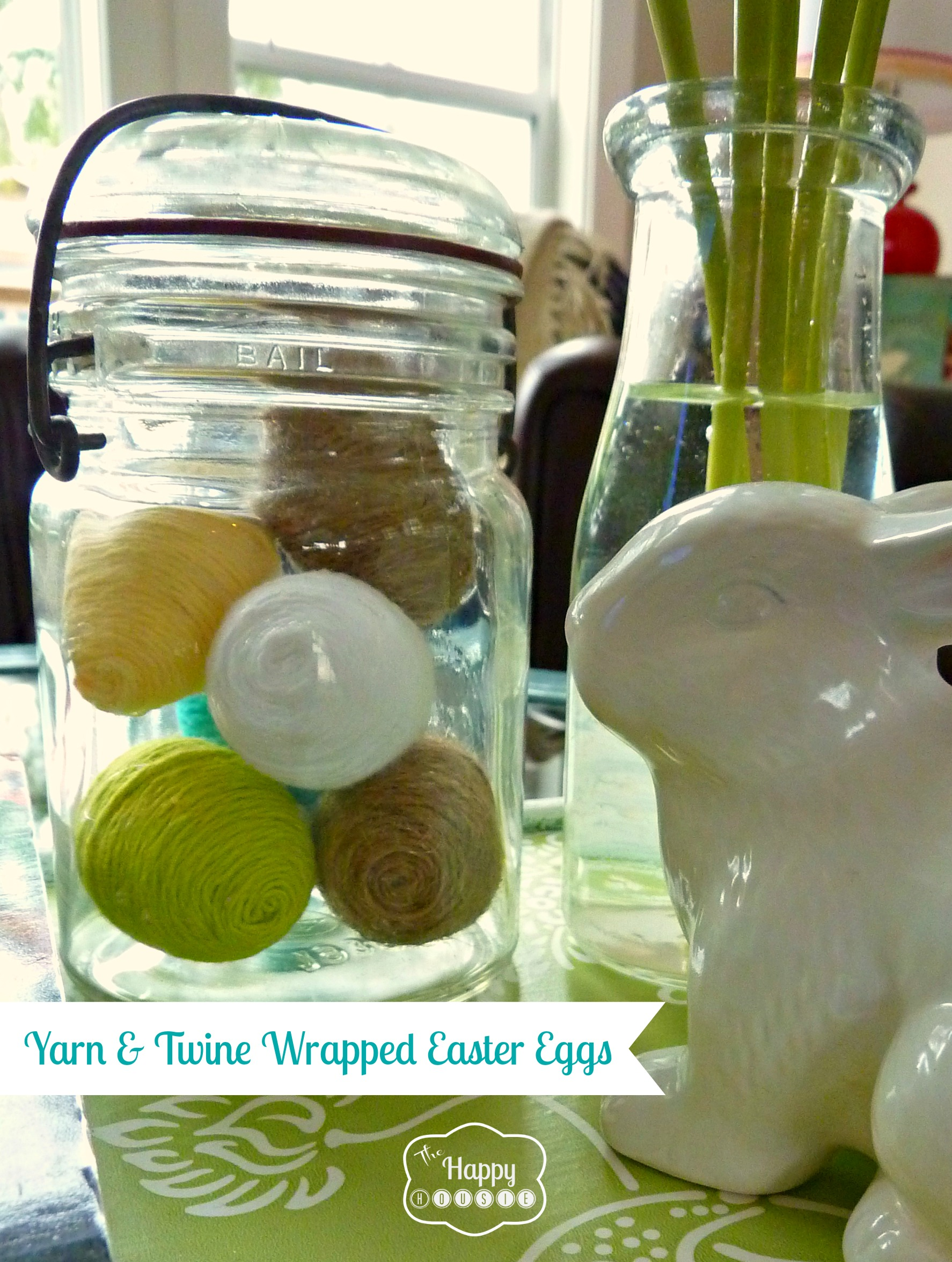 The yarn wrapped Easter eggs displayed on the table.