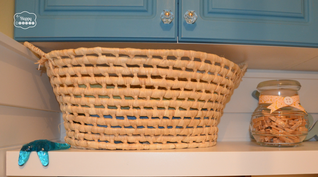 Laundry Room after closeup storage shelf woven basket jar storage turqouise chalk paint cabinets at thehappyhousie