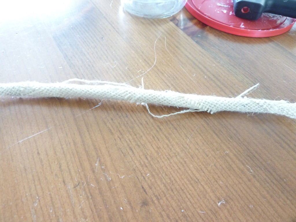 A little rolled piece of burlap on the table.