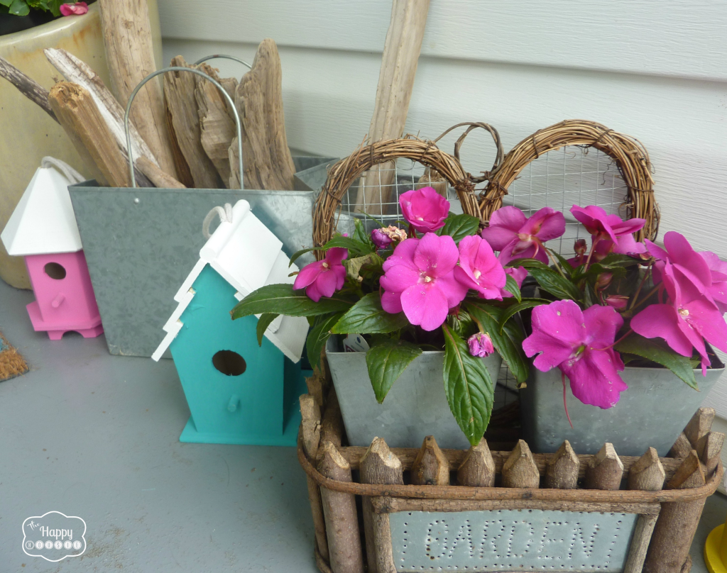 front porch little birdhouses and pink impatients. 