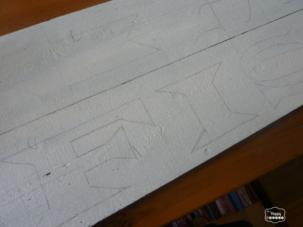 The letters traced onto the piece of wood.