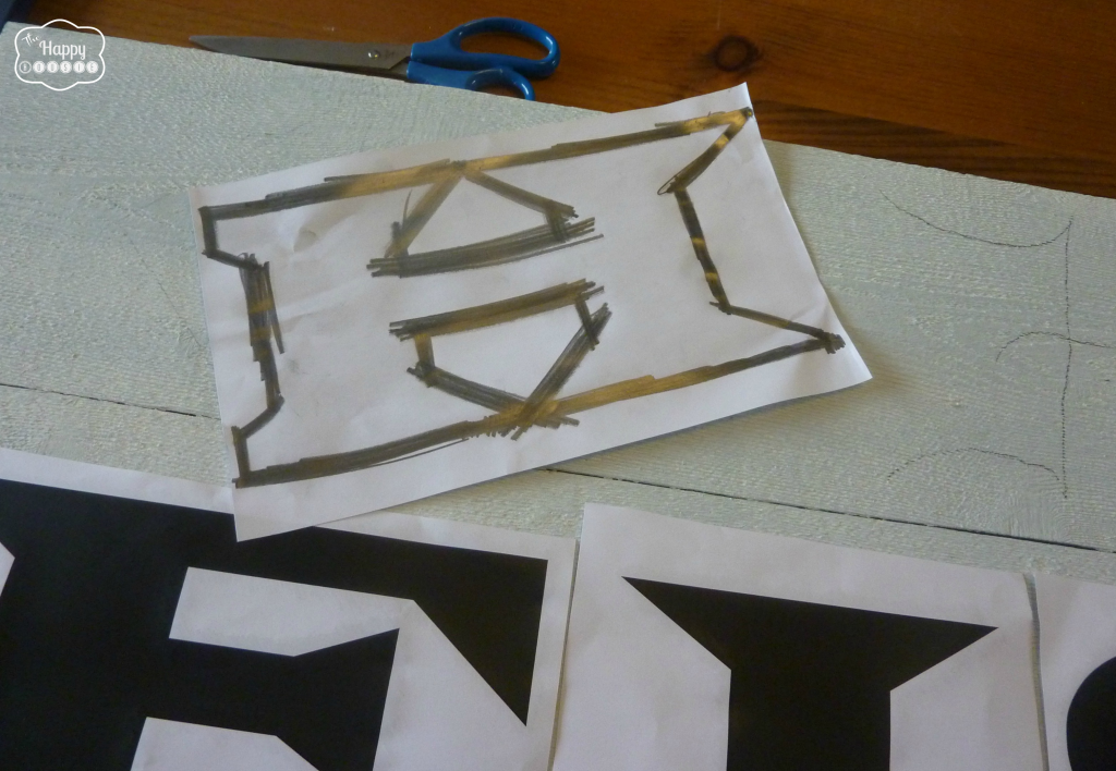 Laying out letters onto a stencil.