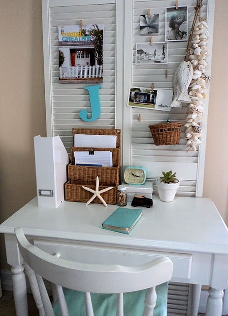 A small white desk with blue accents.