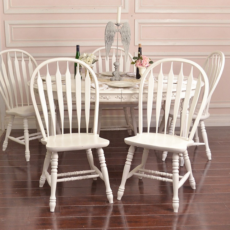 A white dining room table and chairs.
