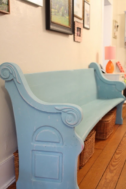 A wooden bench painted blue in the dining room.