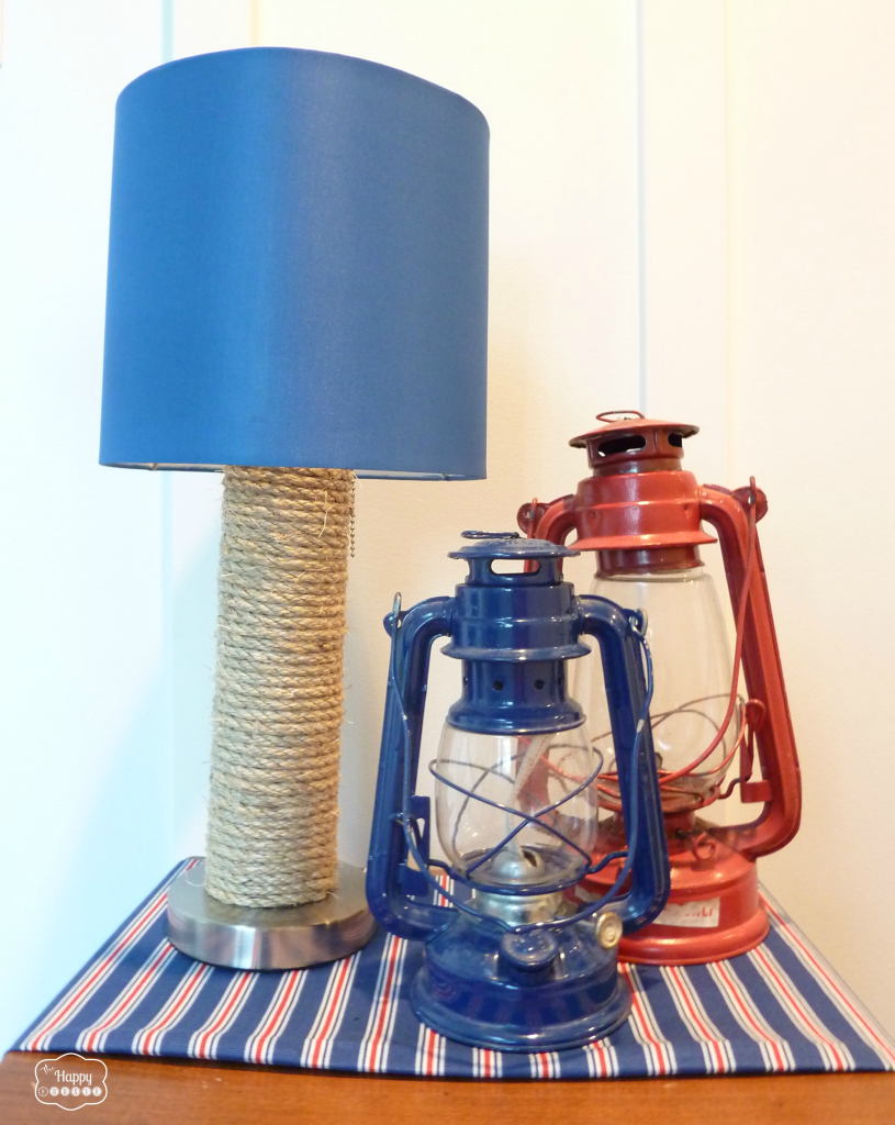 The completed lamp on the table with lanterns in blue and red beside it.