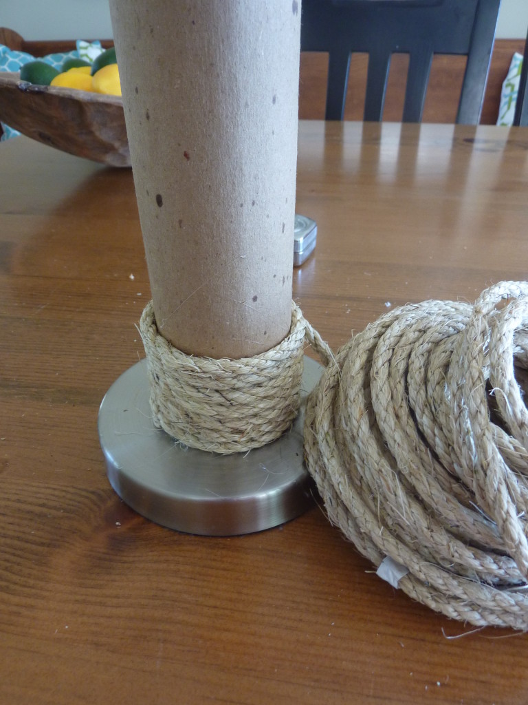 Continuing to wrap the rope around the lamp base.