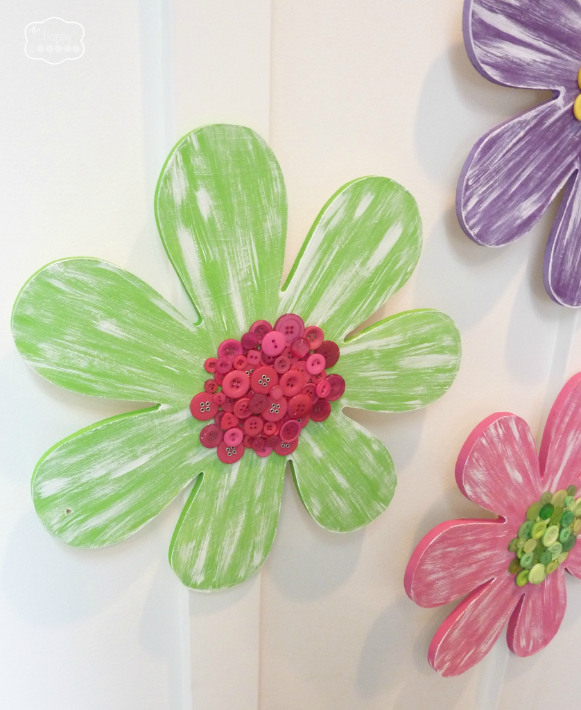 The flowers hanging on the wall by velcro strips.
