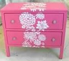 The nightstand inspiration with two drawers and white stenciled flowers.