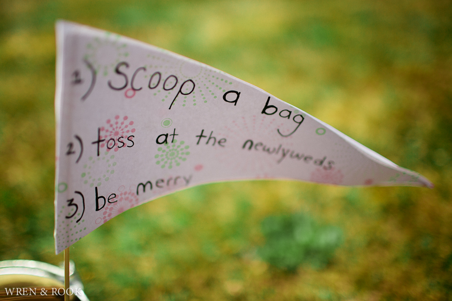 A flag saying scoop a bag and toss at the newlyweds.