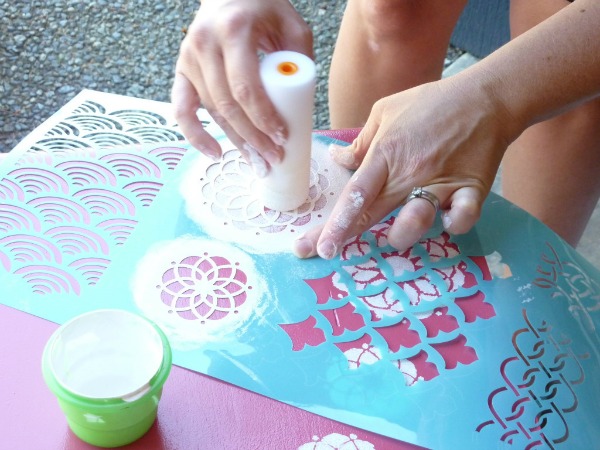 Using the foam roller to stencil the flowers.