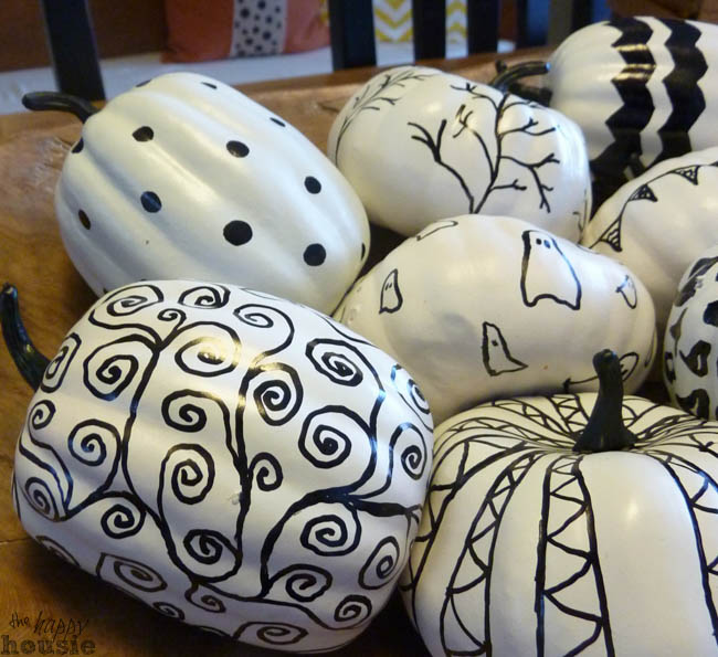 The white pumpkins with sharpie designs on them.