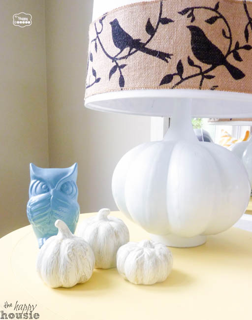 Gold crackle pumpkins and an owl are on the table beside the lamp.