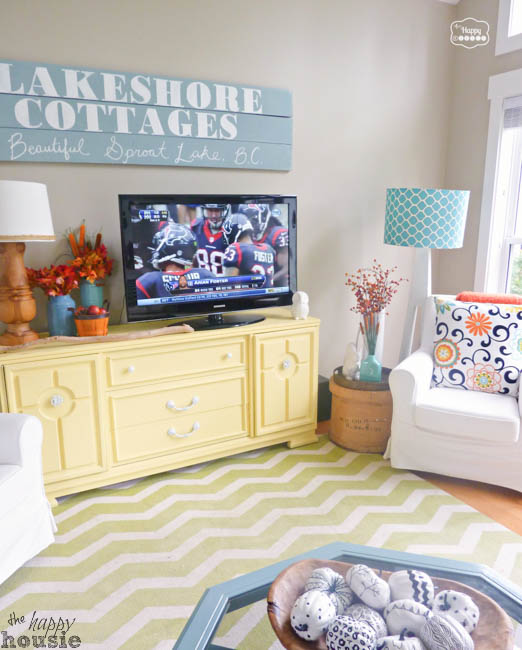 Lakeshore Cottages sign is above the TV console in the living room.