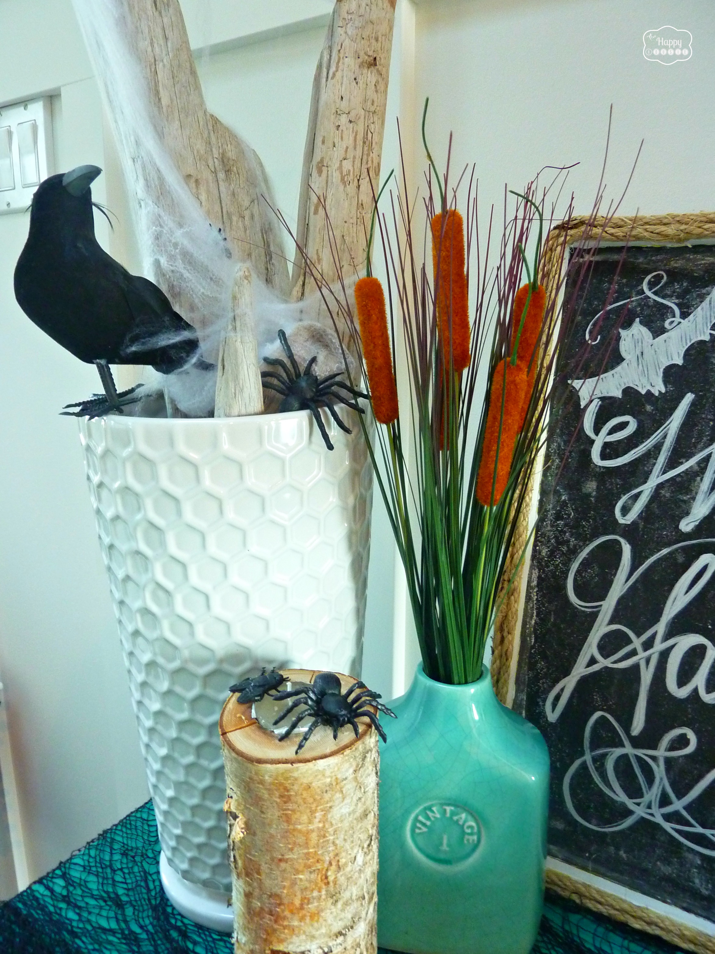 A black crow in a white vase and a blue vase.