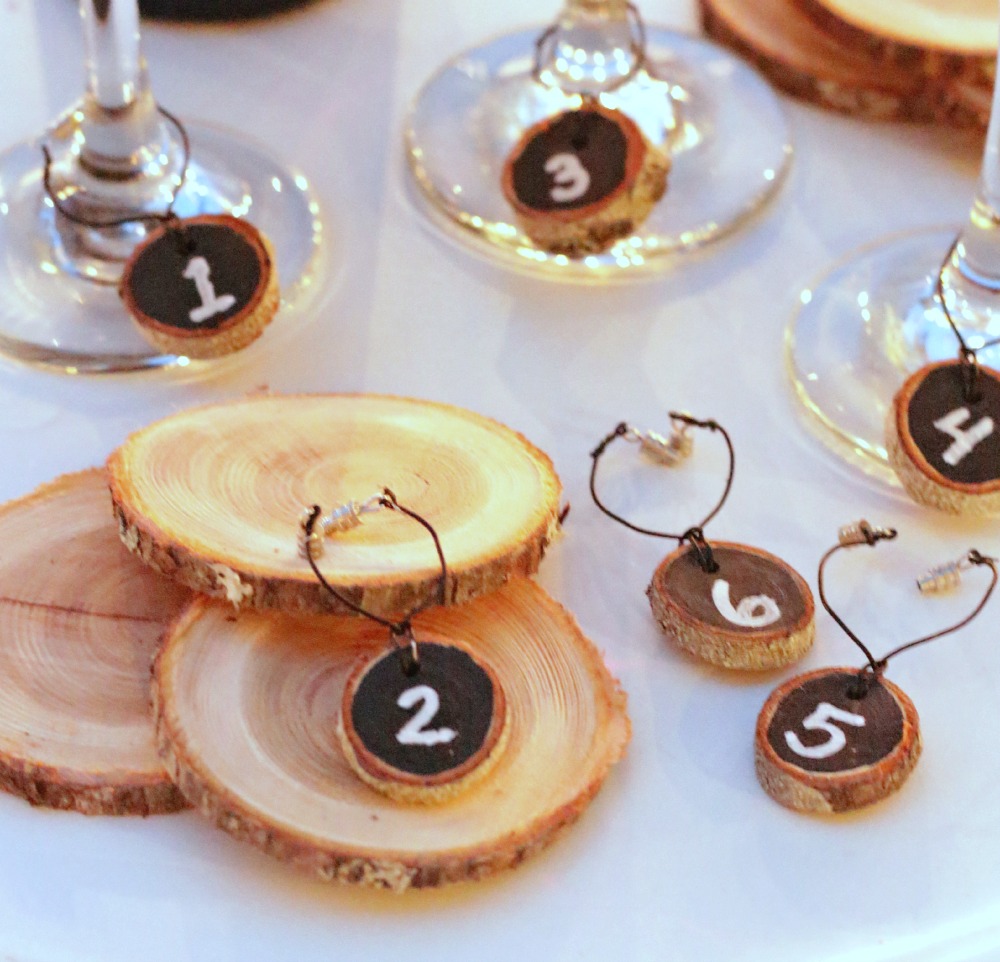The numbered wood slice charms on the table beside wine glasses.