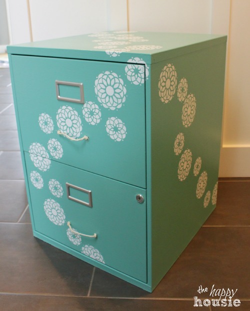 A filing cabinet painted light blue with white flowers.