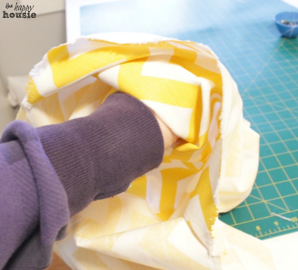 Turning the just sewn fabric inside out.