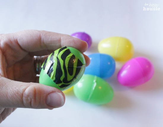Putting the tape on the Easter eggs.
