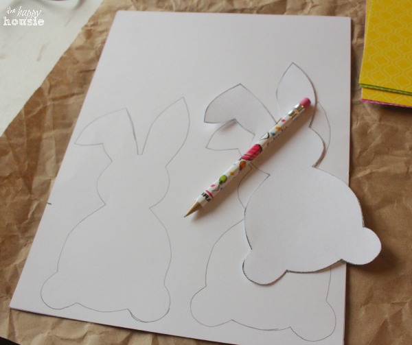 Cutting a traced bunny out of paper.