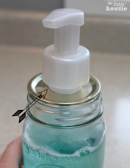 Putting the soap dispenser fitting in the soap jar.