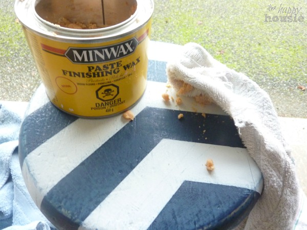 Applying Miniwax to the stool with a cloth.