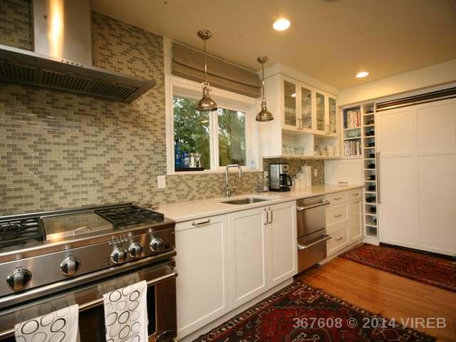 White cabinets, stainless steel oven and dishwasher in the large kitchen.