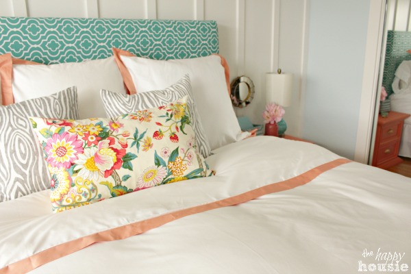 There is a floral pillow on the bed.