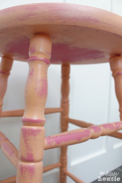 The underneath of the pink stool.