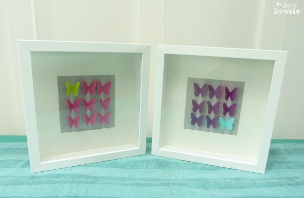 The framed butterfly art displayed.