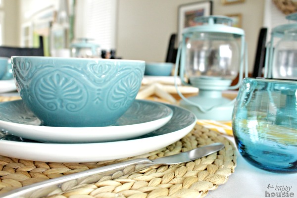 A neutral placement is underneath the turquoise dishes.