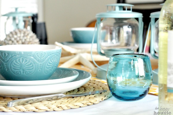Blue glass and lanterns on the table.