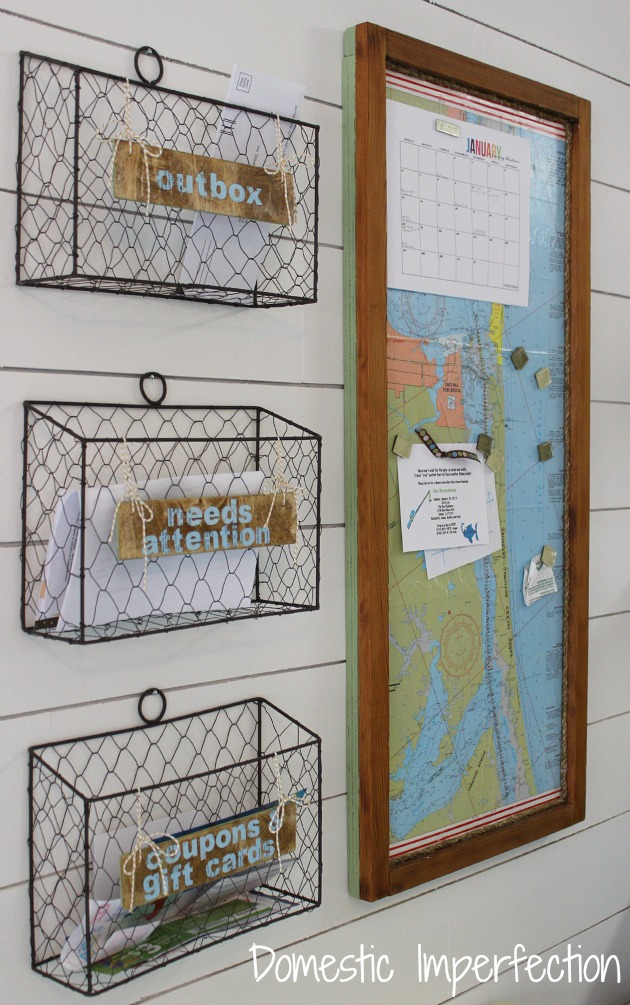 Wire baskets that need attention, outbox and gift cards on the wall beside a map.