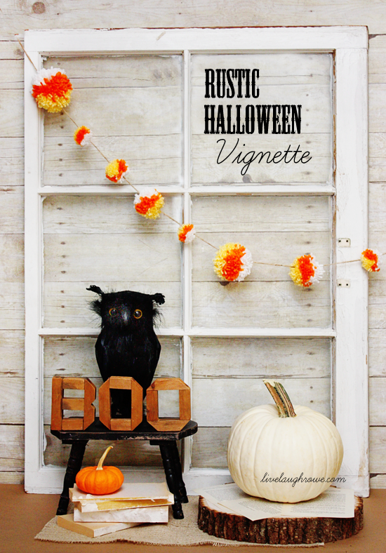 A rustic Halloween vignette with an owl on a bench and a white pumpkin.  There is a pouf garland in white, orange and red.