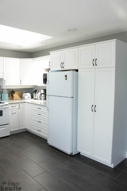 A white fridge and cabinets in the kitchen.