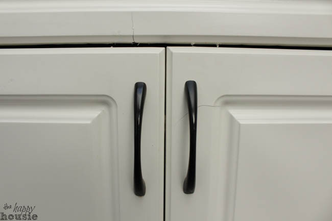 The black handles of the cabinets.
