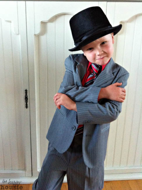 The boy in the suite with a black hat giving spy attitude.