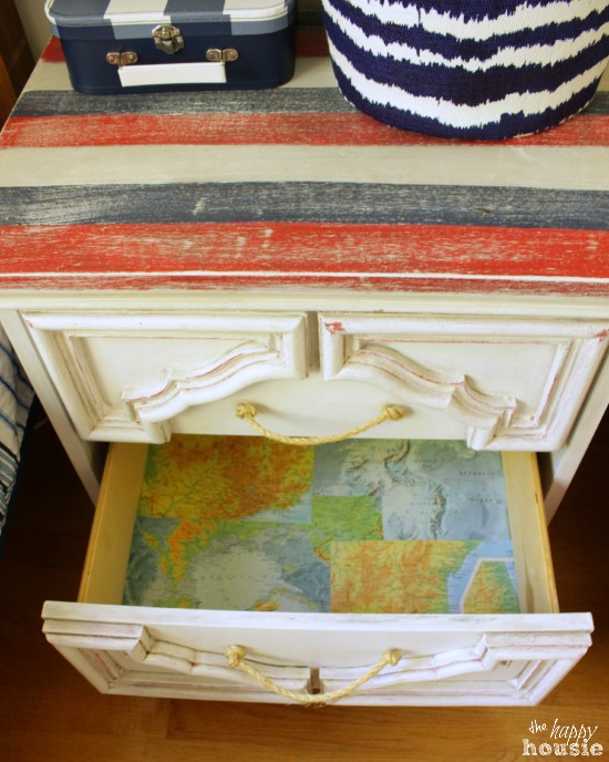The nightstand with one drawer open revealing the map inside.