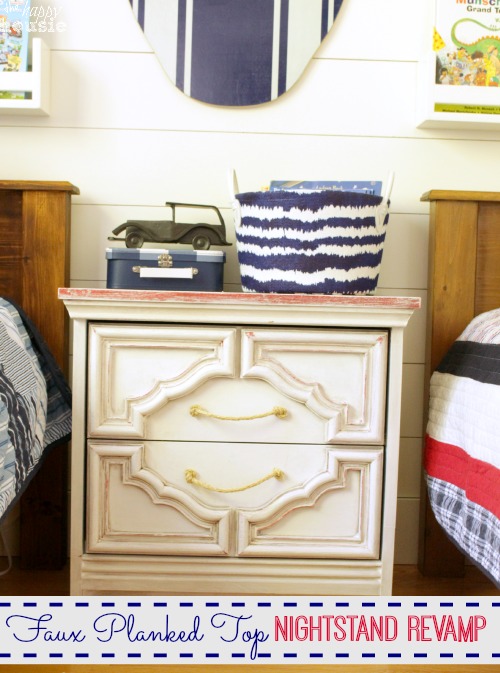 Chunky Nautical Nightstand with Red White and Blue Faux Planked Top in the bedroom between two beds.