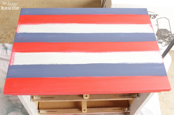 Blue, white and red stripes on top of the nightstand.