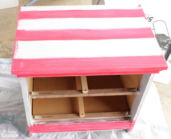 Red painted stripes on the top of the furniture.