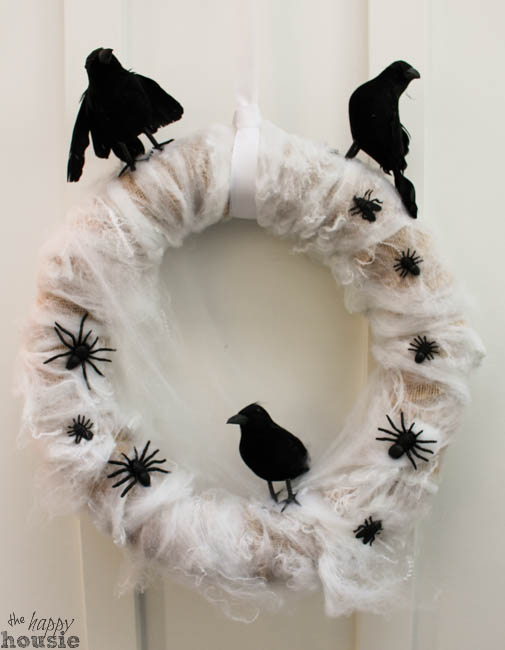 There are three crows on a wreath, plus spiders.