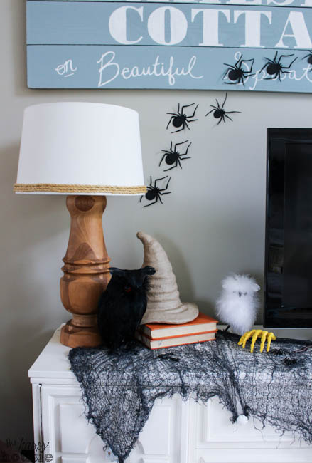 The black spiders crawling up the wall, a black owl on the tv console and a witches hat.