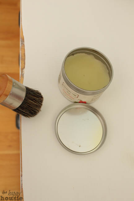 A can of wax and a hard wax brush.