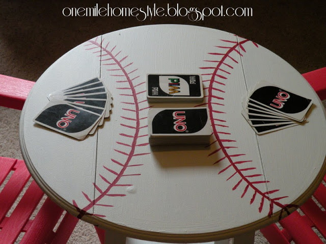 A white round table to look like a baseball with Uno card on top of it.
