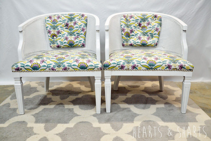 White chairs with floral cushions.